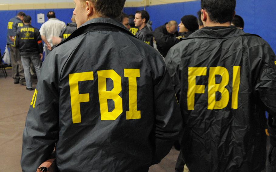 FBI agents are shown during processing in Brooklyn, N.Y. in this January 2011 file photo.