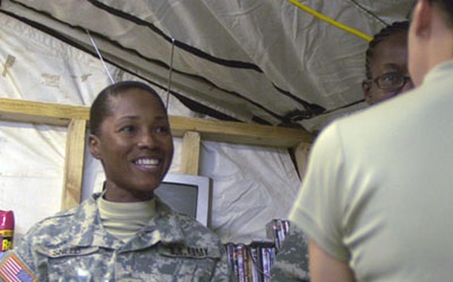 Spc. Detra Sneed, 42, attends to a patient in early December at a 3rd Infantry Division aid station at Forward Operating Base Kalsu, Iraq. Sneed is one of several soldiers who has deployed after the Army raised its maximum enlistment age to 42.   