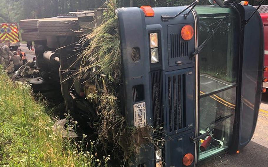 This photo shows a military transport bus that wrecked on state Route 10 in Prince George, Va., Monday, June 7, 2021. The bus was carrying 25 members of the Air National Guard 192nd Security Forces from Joint Base Langley-Eustis in Hampton to Fort Pickett near Blackstone when the accident occured.