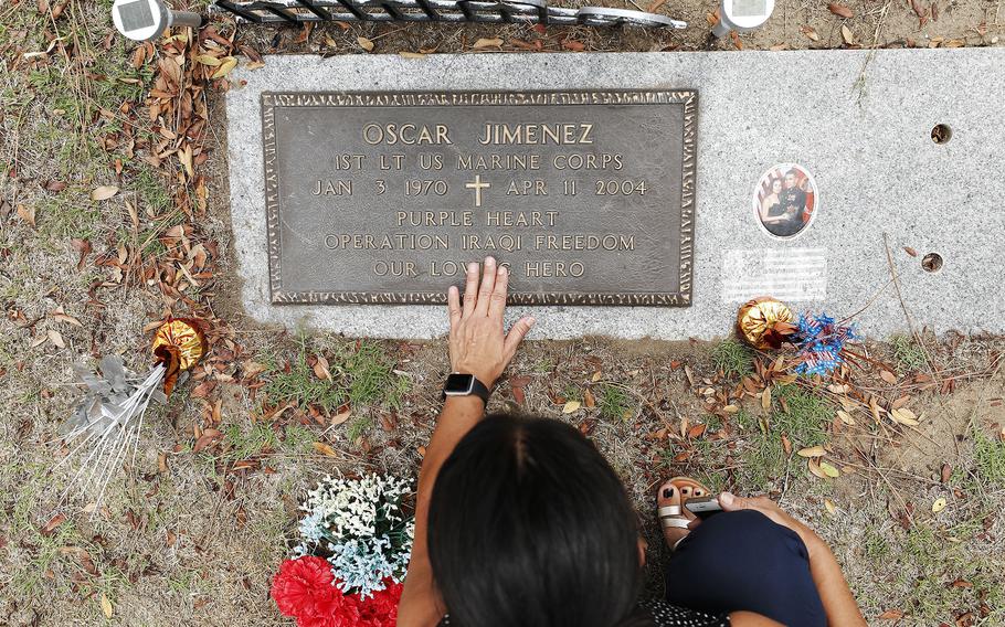 Sonia Jimenez visits the grave of her late brother Oscar Jimenez at Greenwood Memorial Park on Sunday, August 15, 2021, in San Diego, CA. 1st Lt. Oscar Jimenez, 34, was killed in an ambush while serving near Fallujah, Iraq in 2004 . 