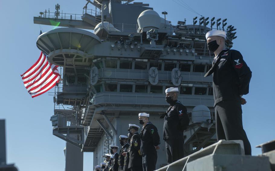 Sailors man the rails on the flight deck of the aircraft carrier USS Nimitz on Feb. 26, 2021.
