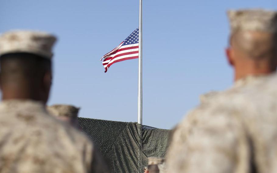 The United States colors fly at half staff at the 9/11 memorial ceremony at Camp Leatherneck, Afghanistan, on Sept. 11, 2011. 