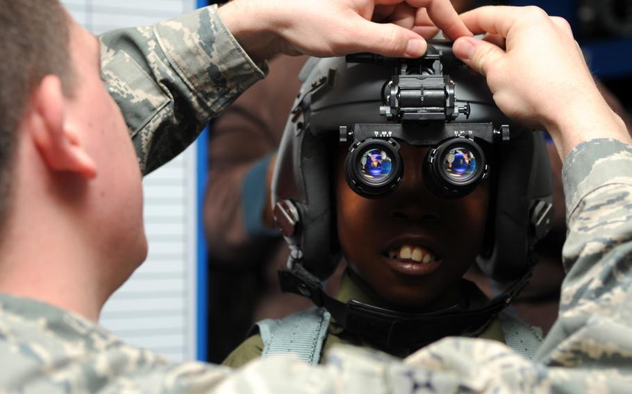 Airman 1st Class Luke Locken, 4th Operations Support Squadron aircrew flight equipment technician, adjusts night vision goggles on Jeremiah Seaberry during a 4th Fighter Wing Pilot for a Day event on Friday, April 3, 2015, at Seymour Johnson Air Force Base, N.C.