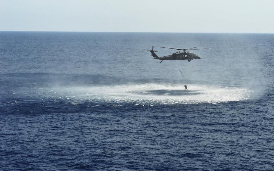 An HH-60G Pave Hawk assigned to the 33rd Rescue Squadron drops off two pararescuemen during the Forceful Tiger exercise over the Pacific Ocean on Wednesday, April 1, 2015.