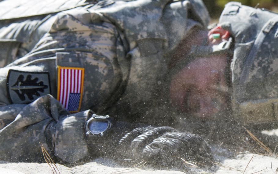 Army Reserve Sgt. Rob Caruso, from Atco, N.J., low crawls during the reflexive fire exercise during day three of the 200th Military Police Command?s Best Warrior Competition on April 2, 2015 at Joint Base McGuire-Dix-Lakehurst, N.J.