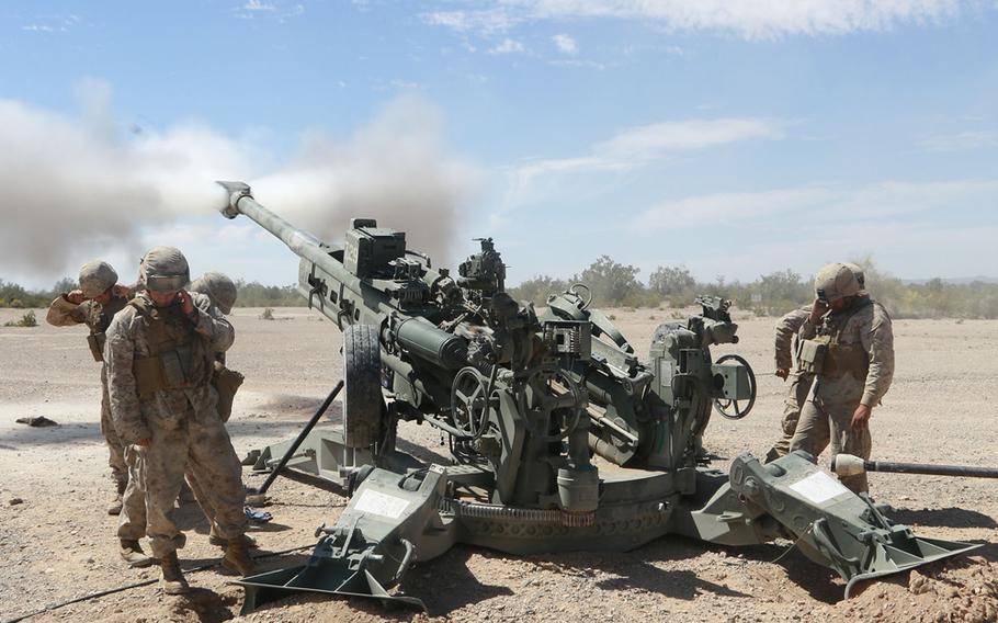 U.S. Marine Corps artillerymen assigned to 1st Battalion, 10th Marines, fire 155mm rounds using an M777 Howitzer weapons system during an artillery raid exercise on April 4, 2015 in Yuma, Ariz.