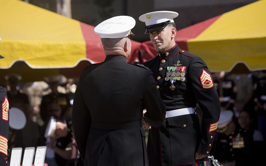 U.S. Marine Corps Maj. Gen. Joseph L. Osterman, commander, Marine Special Operations Command, Camp Lejeune, N.C., presents Gunnery Sergeant Brian C. Jacklin, Team Chief, Delta Company, 1st Marine Special Operations Battalion, Marine Special Operations Command, with the the Navy Cross Medal during a ceremony held to honor Jacklin and five other members of Marine Special Operations Team 8131 at Camp Pendleton, Calif., April 9, 2015.