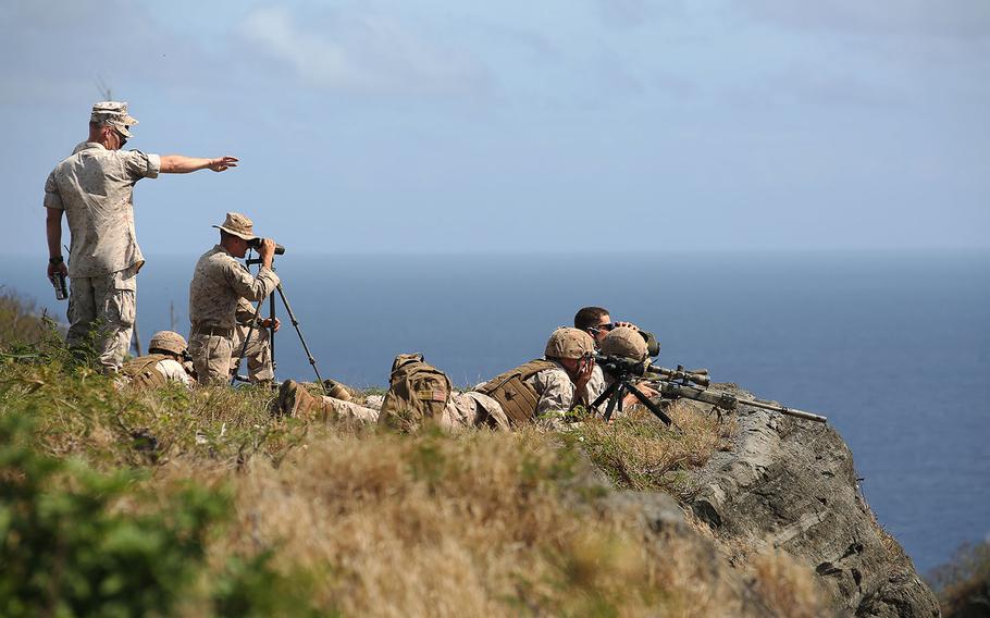 Marine scout snipers with Weapons Company, 2nd Battalion, 3rd Marine Regiment, conduct high angle shooting on top of Ulupau Crater at Range 10 at Marine Corps Base Hawaii, April 8, 2015.