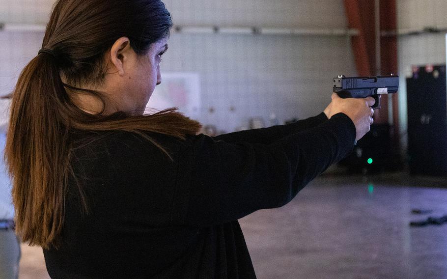 Beatriz Medina fires a replica Glock pistol while using the Squad Advanced Marksmanship-Trainer during a marksmanship exercise Jan. 16, 2020 at the Virtual Training Facility on Fort Knox, Ky.