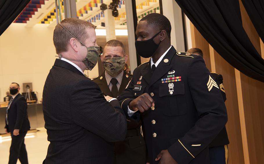 Army Secretary Ryan D. McCarthy greets the 2020 Soldier of the Year, Sgt. James Akinola, at the opening of the National Museum of the United States Army, Fort Belvoir, Va., on Nov. 11, 2020.