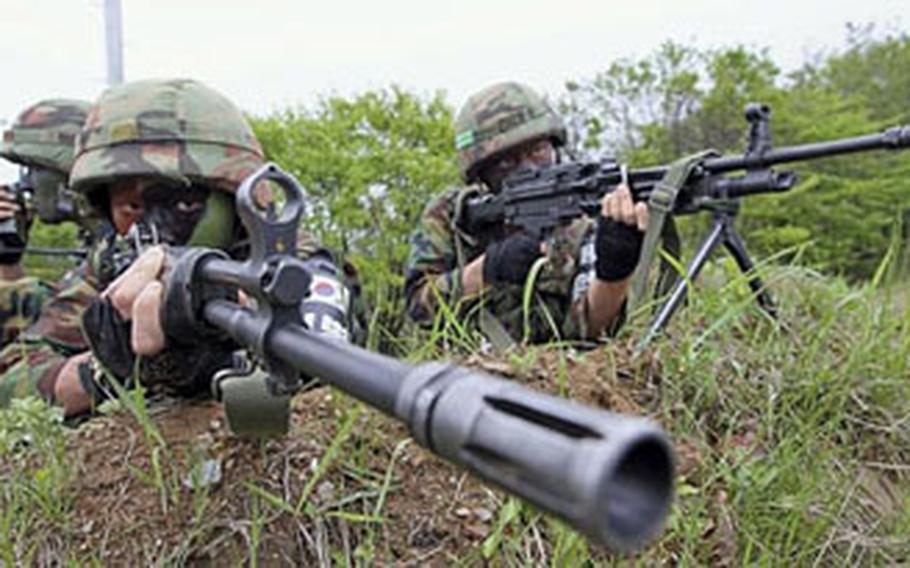 South Korean artillery soldiers take positions during an exercise against possible North Korean attacks, in Paju, South Korea, near the demilitarized zone between the two Koreas, Monday. South Korean artillery soldiers take positions during an exercise against possible North Korean attacks, in Paju, South Korea, near the demilitarized zone between the two Koreas, Monday.