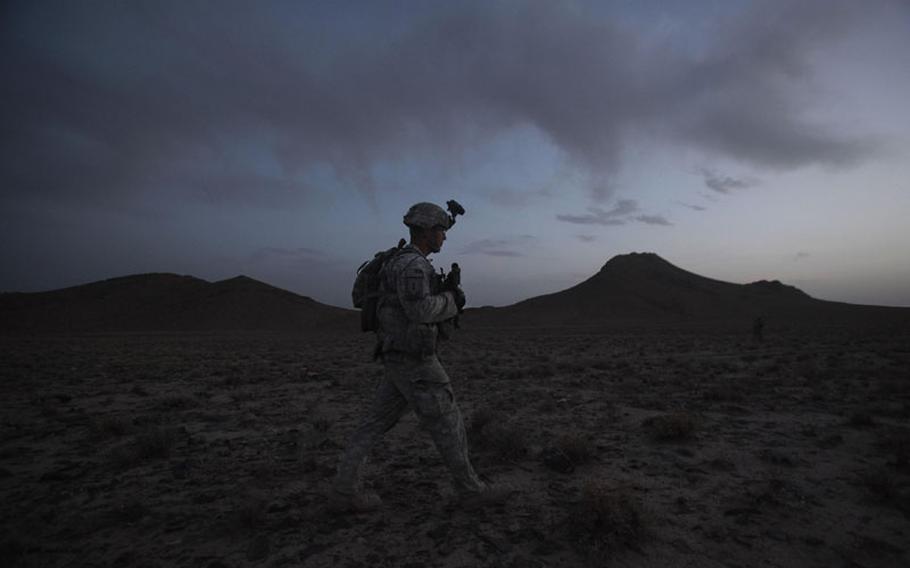 United States Army Staff Sgt. Rande Henderson of Helena, Mont., sets out at dusk with members of 2nd Platoon, Charlie Company, 1st Battalion, 17th Infantry Regiment of the 5th Stryker Brigade to set up an ambush for Taliban fighters Friday, May 21, 2010, in Afghanistan's Kandahar province.