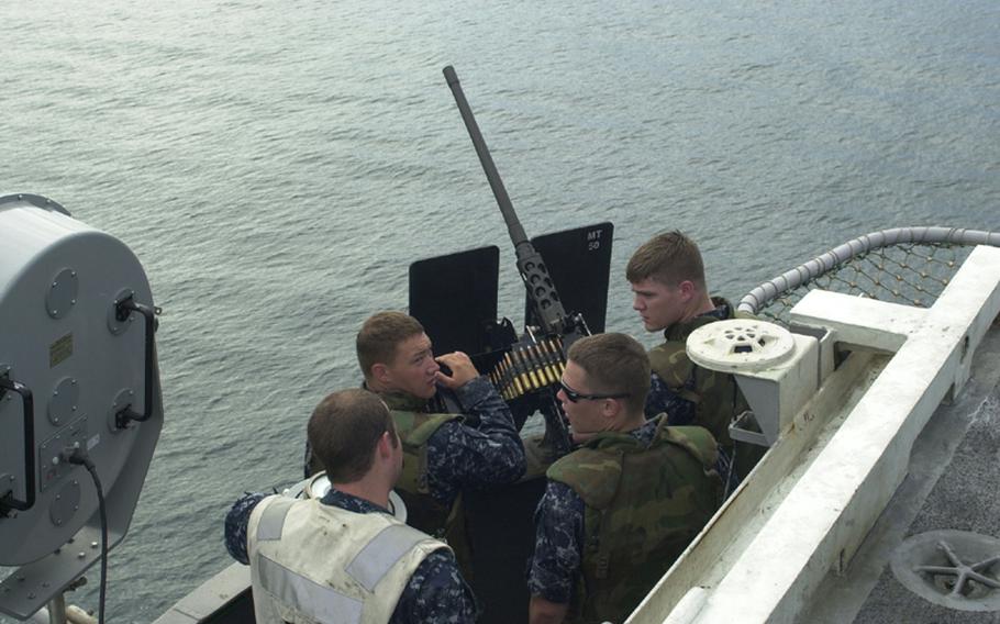 Crew from the USS George Washington man a machine gun during the Invincible Spirit military exercise Sunday in the Sea of Japan.      