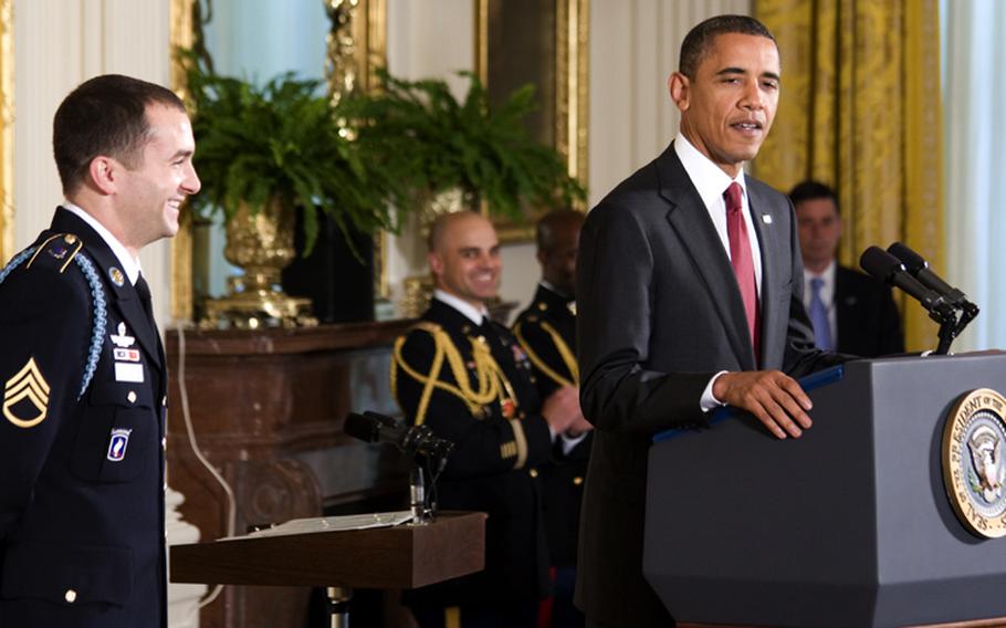 Staff Sgt. Salvatore Giunta laughs as President Barack Obama recounts how Guinta’s mother taught him how to remove the screens from his bedroom windows, “teaching Sal how to sneak off in the dead of night” and “unleashing a future paratrooper who would one day fight in the rugged mountains of Afghanistan 7,000 miles away.”