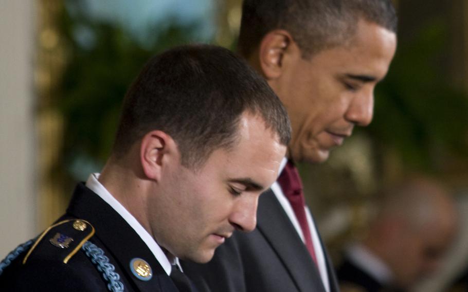 Staff Sgt. Salvatore Giunta and President Barack Obama pause for prayer during Tuesday’s Medal of Honor ceremony at the White House.