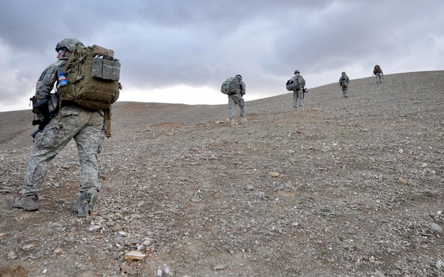 Soldiers with the 173rd Airborne Brigade Combat Team’s Company C, 1st Battalion, 503rd Infantry Regiment patrol above the Tangi Valley in Wardak province, Afghanistan. Top right: Staff Sgt. Terek Khalil, a medic from the 503rd’s 2nd Battalion, treats and bandages an arm injury on a child in Chiriac Valley, Afghanistan, on Oct. 24. Bottom right: A medic with the 503rd’s 1st Battalion treats an Afghan flood victim near Combat Outpost Nerkh in Wardak province Aug. 11.