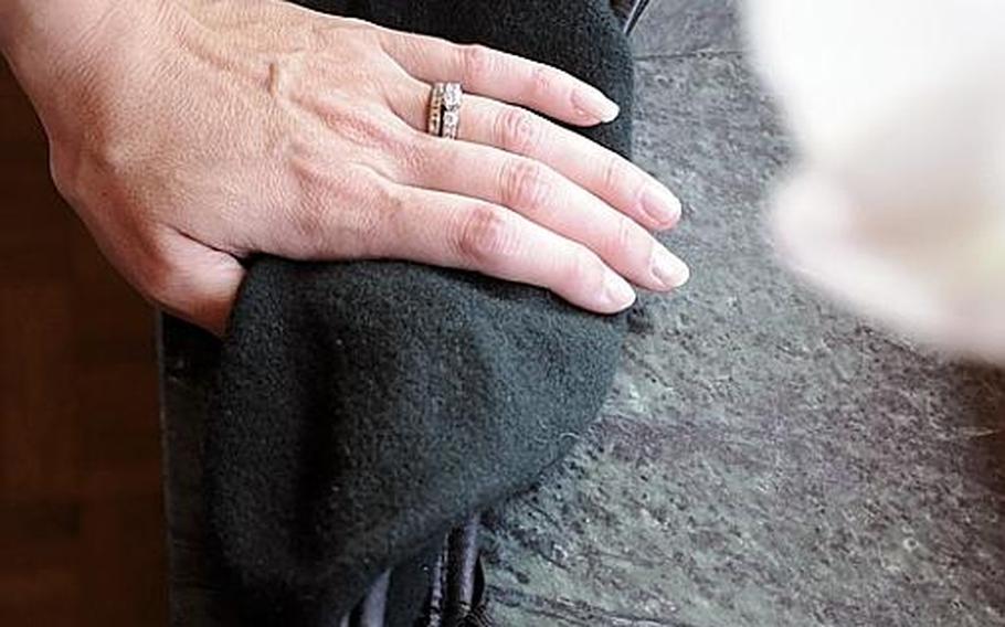 While gazing out a window, Meredith holds the Green Beret of her husband Brandon who is in 1st Battalion, 10th Special Forces Group stationed in Stuttgart. She is also manager for the unit's Family Readiness Group where she helps other Special Forces family members deal with the turmoil inherent to being part of Special Forces.