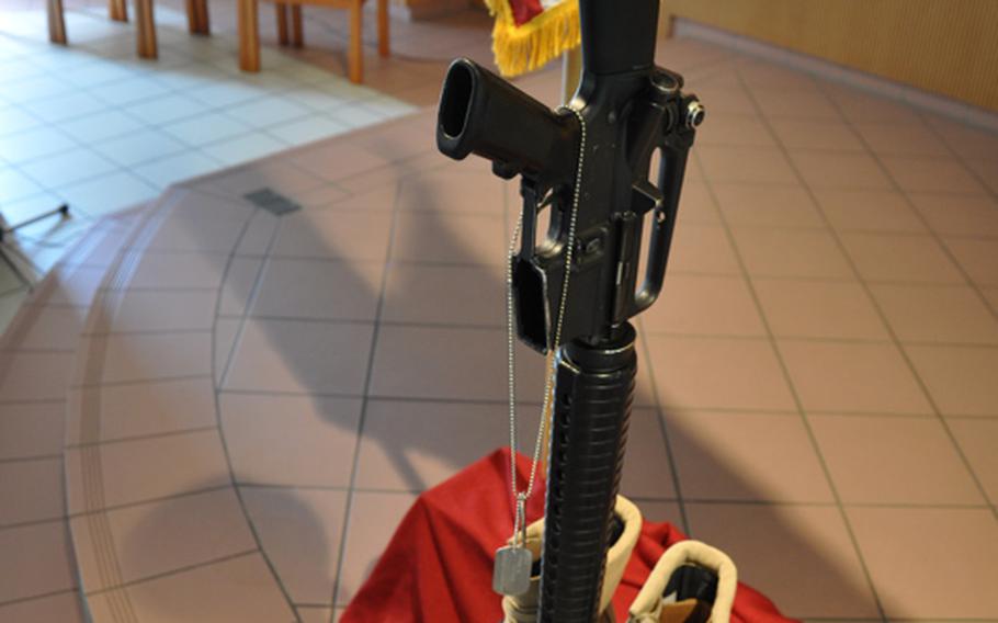 A helmet, weapon and boots stand in honor of Staff Sgt. David D. Self during a memorial service Monday in Vilseck, Germany. Self died May 16 from wounds suffered during an insurgent attack in Afghanistan.
                