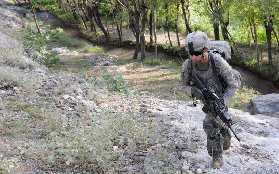 U.S. Army Spc. Joshua Barnett of Springfield, Mass., a rifleman with 1st Platoon, Company A, 1st Battalion, 327th Infantry Regiment, Task Force Bulldog, climbs to a ridge in Kunar province in eastern Afghanistan Sept. 16. International Security Assistance Forces and Afghan National Security Forces often patrol the Watahpur Valley area together to prevent insurgents from moving freely through the area and staging attacks.