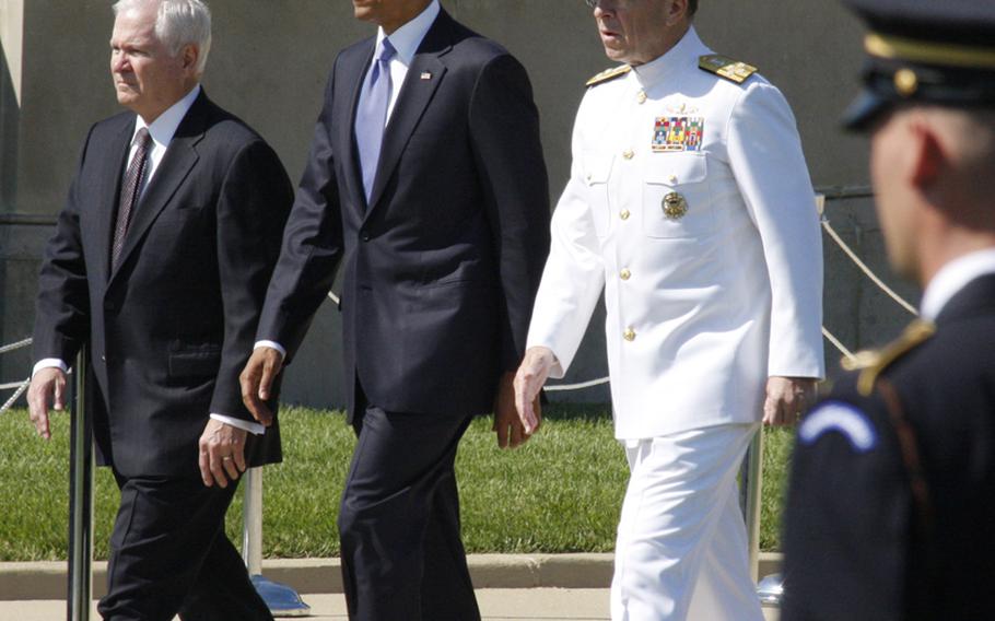 Outgoing Defense Secretary Robert Gates, President Barack Obama and Adm. Mike Mullen, chairman of the Joint Chiefs of Staff, at a Pentagon ceremony Thursday honoring Gates' time in office.