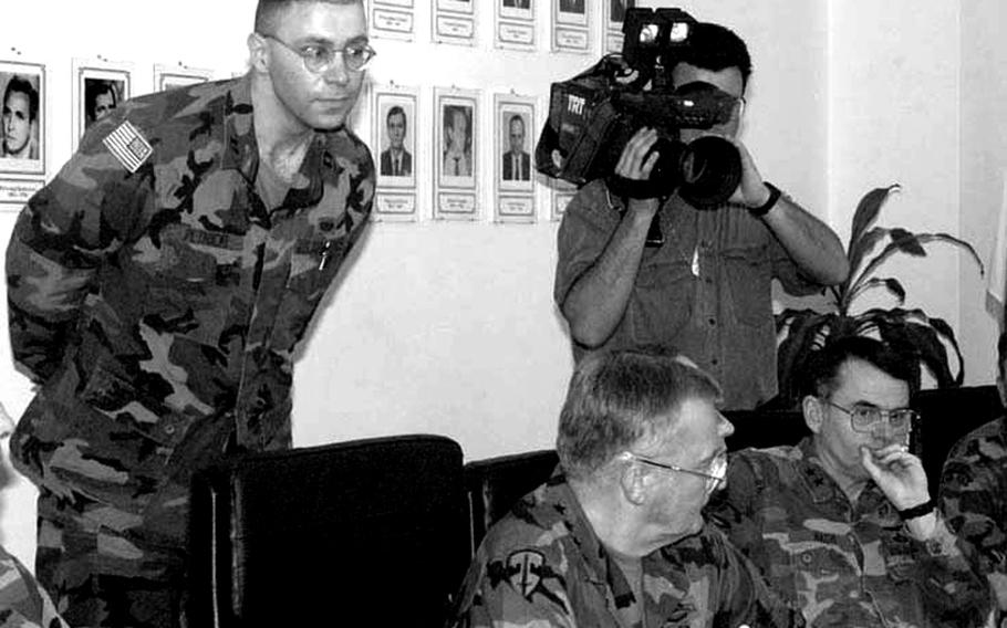 Capt. Vlad Petmicki, the top Serbo-Croatian interpreter in the U.S. Air Force, leans forward to catch the words of Zenica mayor Besim Spahic's speech so that he can translate it for General John Shalikashvili, center.