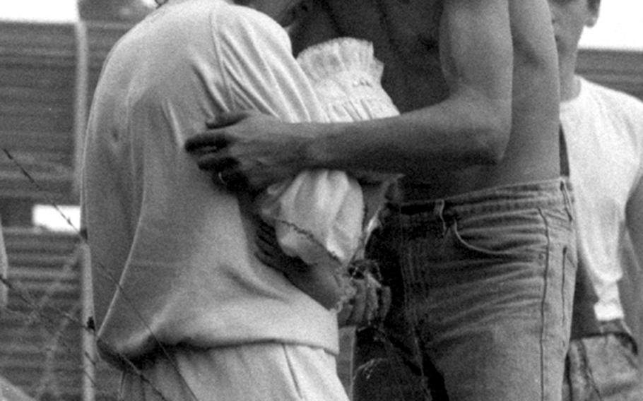 A woman is comforted after witnessing the crash at the Ramstein Air Show on Aug. 28, 1988.