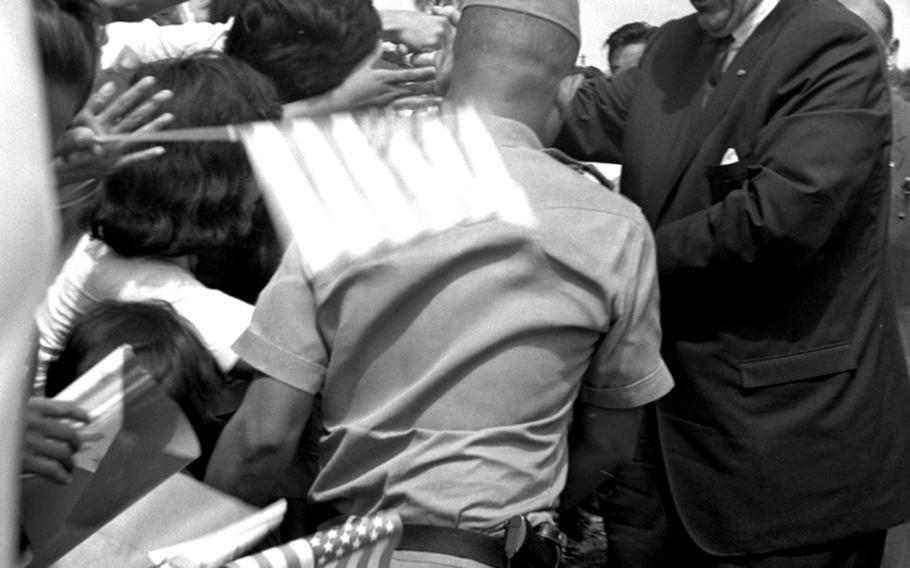 President Lyndon Johnson enthusiastically shakes hands with Filipinos during the Manila Summit.