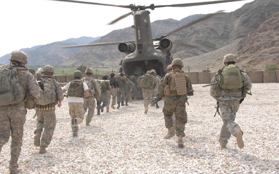 U.S. Army Soldiers, 2nd Battalion, 503rd Infantry Regiment, 173rd Airborne Brigade, the Afghan National army soldiers, and the Afghan Border Patrol conduct training on how to enter and exit a CH-47 Chinook helicopter at Forward Operating Base Fortress, Konar Province, Afghanistan, April 11, 2008, in preparation for operation Rock Tempest.
