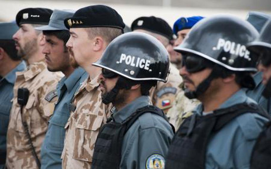 Afghan National Police instructors stand alongside NATO Training Mission-Afghanistan advisers at the National Police Training Center in Wardak province, Afghanistan in April 2011.
                