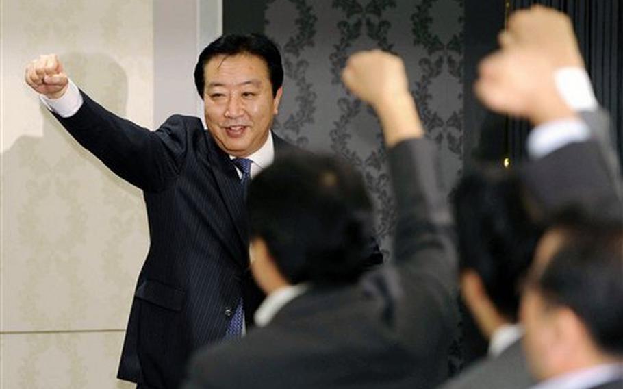 Japan's Finance Minister Yoshihiko Noda (back) raises his fists before his supporters in Tokyo on Aug. 29, 2011, prior to a meeting of his Democratic Party of Japan to hear speeches of candidates before holding a vote to pick a successor to outgoing Prime Minister Naoto Kan.