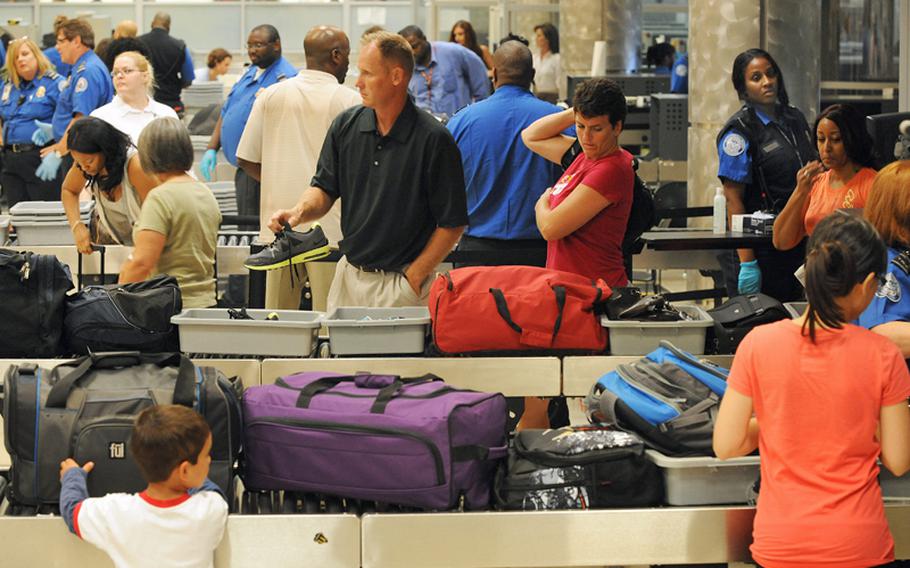 Airline passengers go through the Transportation Security Administration security checkpoint at Hartsfield-Jackson Atlanta International Airport on Wednesday, August 3, 2011 in Atlanta.