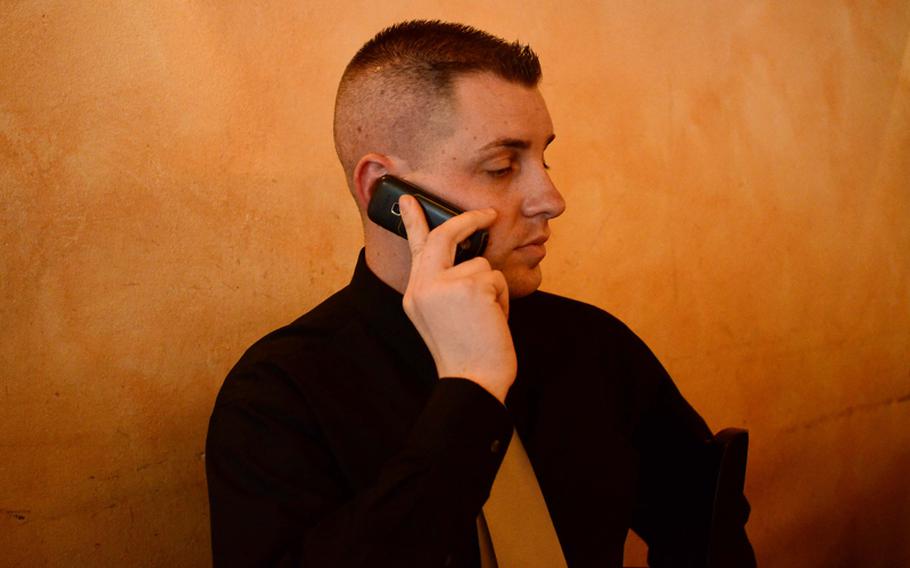 John Tegeler, leader of OutServe Germany and a Staff Sgt. in the U.S. Air Force, handles calls from work and members of OutServe looking for directions to a restaurant in Kaiserslautern, Germany, where members celebrated the repeal of the U.S. Military's "don't ask don't tell" policy.