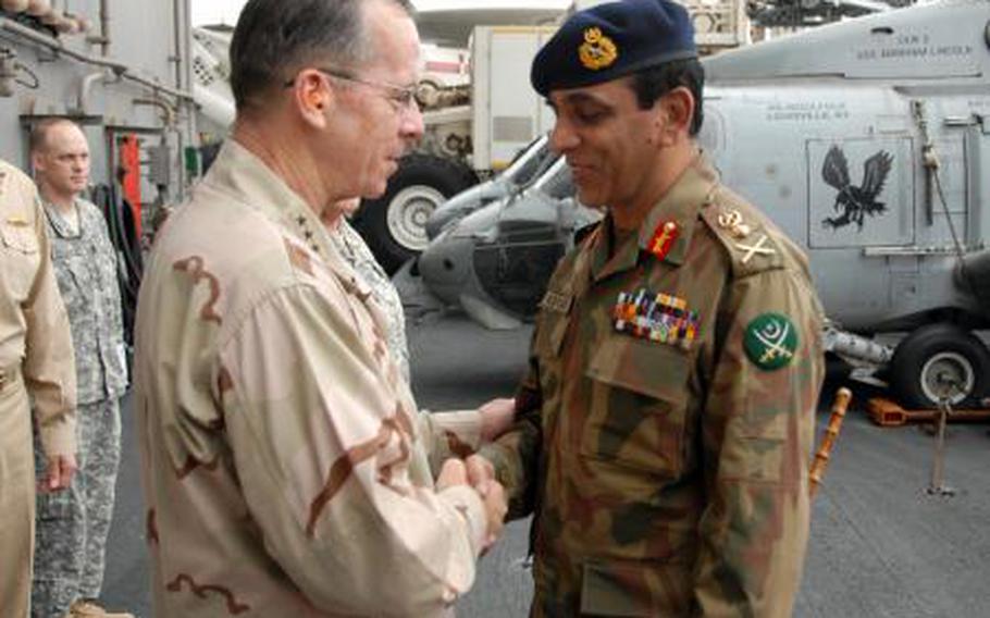 Adm. Mike Mullen, chairman of the Joint Chiefs of Staff, greets Pakistani Chief of Army Staff, Gen. Ashfaq Kayani, after arriving aboard the aircraft carrier USS Abraham Lincoln in 2008.