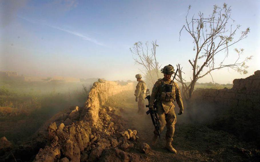 Platoon Leader 2nd Lt. Timothy Gonski, front, and Sgt. Frank Iannaccone of Company C, 1st Battalion, 32 Infantry Regiment, 3rd Brigade Combat Team, 10th Mountain Division, front, inspect a wall after blowing an anti-personnel obstacle breaching system during Operation Steel Lion III on August 27, 2011, at Strong Point Alizi in Kandahar Province, Afghanistan.