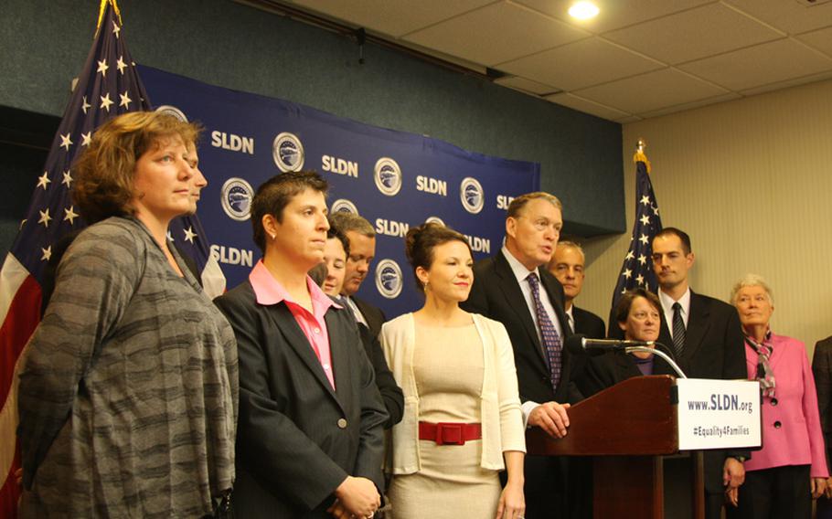 Aubrey Sarvis (center), executive director of the Servicemembers Legal Defense Network, speaks at a Washington, D.C. press conference Thursday announcing a new lawsuit challenging the Defense of Marriage Act. With him are the plaintiffs and their spouses, who argue that a federal law barring them from receiving military benefits is discriminatory.