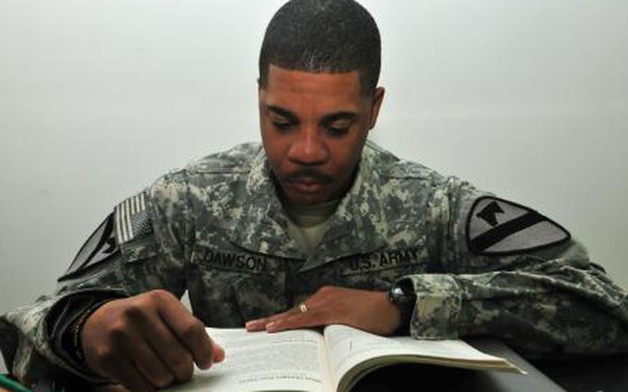 Sgt. 1st Class James Dawson, a Houston native and the equal opportunity advisor for 2nd Brigade Combat Team (Advise and Assist), 1st Cavalry Division, reads a college textbook while deployed at Camp Buehring, Kuwait, Oct. 30. Dawson says online classes have helped him continue his college education throughout his five deployments.