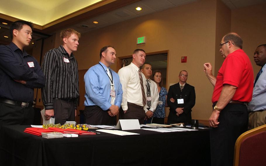 Duane Hardesty, right, Northrop Grumman Operation IMPACT program ambassador for hiring wounded warriors, speaks to service members, July 20, 2011, during Career Opportunity Day in Colorado Springs.