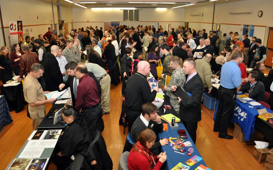 Servicemembers from Oregon interact with employers during the ''Hiring Our Heroes'' job fair at Clackamas Community College in Oregon City, Ore., Nov. 19, 2011.