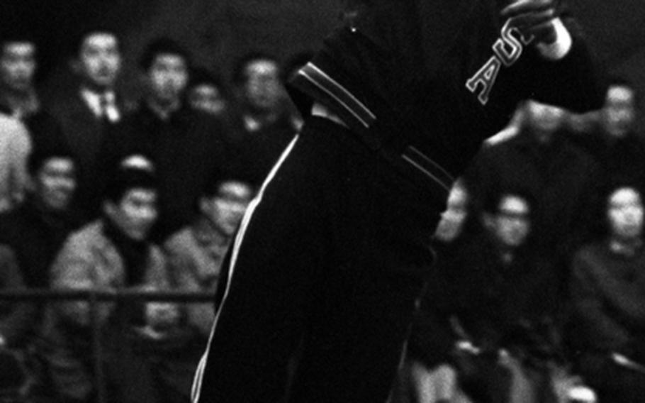 Arthur Ashe serves during a 1969 exhibition match in Tokyo.