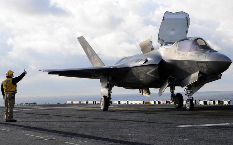 Chief Petty Officer Kristopher Smith gives the thumbs up for pilot Lt. Col. Fred Schenk to lift an F-35B Lightning II off the flight deck of the amphibious assault ship USS Wasp during testing in October, 2011. The F-35B is the Marine Corps Joint Strike Force variant of the Joint Strike Fighter.
