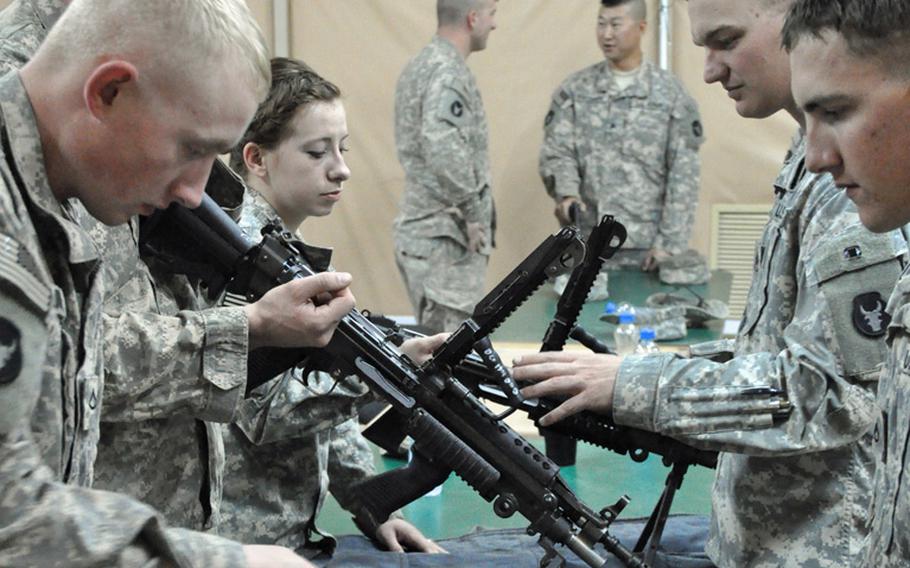 Soldiers with the 1st Brigade Combat Team, 34th Infantry Division of the Minnesota National Guard conduct weapons training at Camp Buehring, Kuwait, last month. The unit was one of many currently deployed that is affected by a Pentagon decision to cut leave days provided to soldiers who have deployed multiple times in a short period. Many of the soldiers will lose about three weeks of paid leave upon returning home.