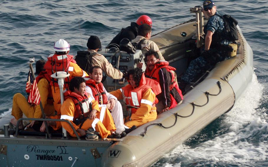 Sailors assigned to the USS John Paul Jones transfer six rescued Filipino mariners to the U.S. Coast Guard Cutter Baranof on March 15, 2012.