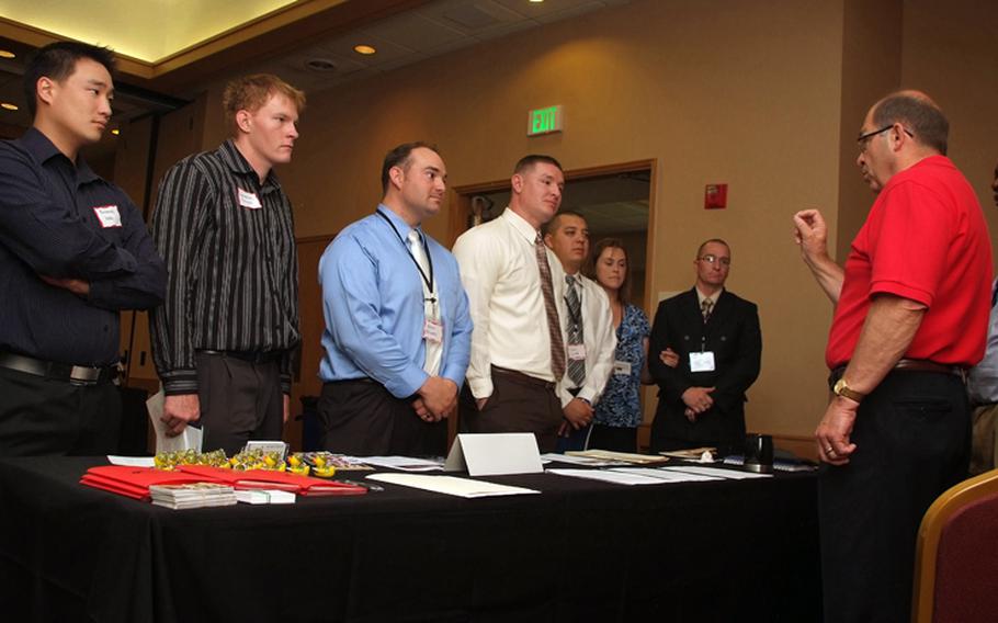 Duane Hardesty, right, Northrop Grumman Operation IMPACT program ambassador for hiring wounded warriors, speaks to servicemembers during Career Opportunity Day in Colorado Springs in July, 2011. USO and Hire Heroes USA hosted the event for injured and ailing service members transitioning into the civilian workforce.