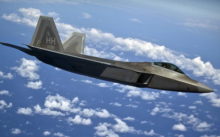 An F-22 Raptor from the 19th Fighter Squadron, Joint Base Pearl Harbor-Hickam, Hawaii waits its turn as its wingman takes on fuel from a 96th Air Refueling Squadron KC-135 Stratotanker on March 27, 2012, over the Pacific near the Hawaiian Islands.