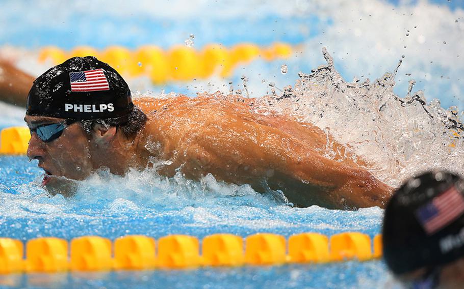 Michael Phelps of the United States on his way to winning the men's 100 meter butterfly at the 2012 Summer Games in London, England, on Aug. 3, 2012. Viewers are complaining about AFN's broadcast schedule of the Olympic games, which has forced some to wait until after midnight to catch the feats of Olympians such as Phelps and Usain Bolt.