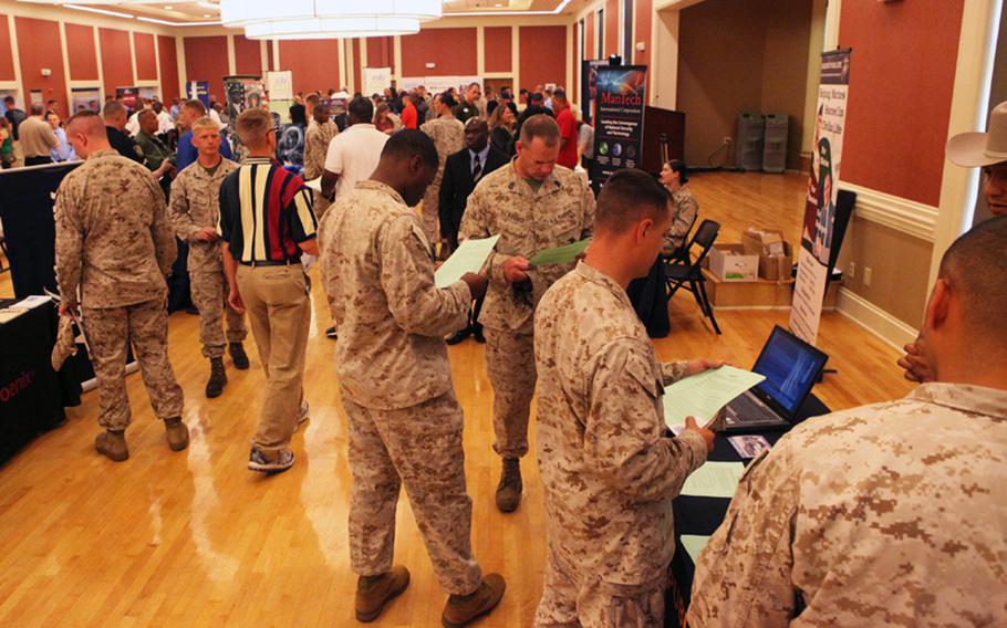 Marines speak with employers during a job fair at Marine Corps Base Camp Lejeune on July 19. More than a dozen companies, departments and organizations spoke to service members, military spouses and base patrons at the function.