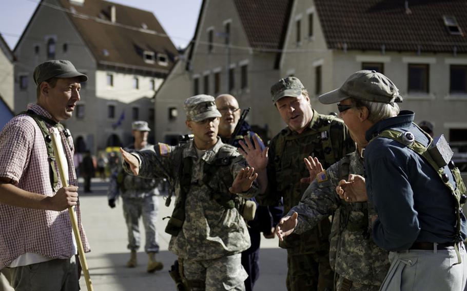 U.S. Army soldiers from the 1st Battalion, 118th Infantry Regiment, Joint Regional Detachment, South Carolina National Guard, de-escalate the situation between Albanian and Serbian, role players, during readiness training for Kosovo Force 16, Joint Multinational Readiness Center, Hohenfels, Germany, Aug. 20, 2012.