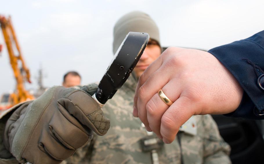 In this file photo, Staff Sgt. Kevin Rivera, Air Force Radiation Assessment Team, checks a servicemember for radiation at Onahama port, Fukushima Prefecture.