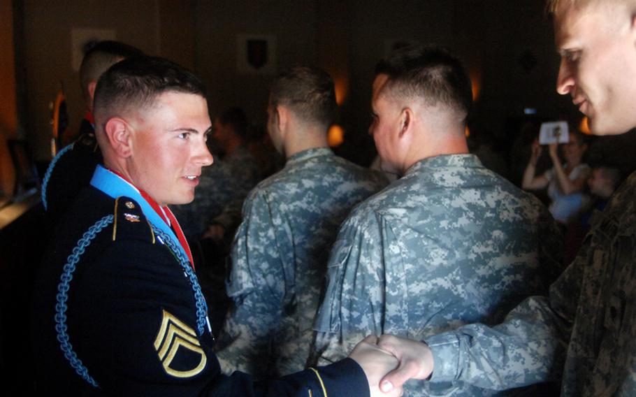 Staff Sgt. Johnathan Ray, left, a squad leader in Company B, 3rd Battalion, 66th Armor Regiment, 172nd Separate Infantry Brigade, is congratulated by fellow brigade members Friday following his induction into the Sergeant Audie Murphy Club in Grafenwöhr, Germany. Ray was one of 14 brigade members inducted into the club, an organization that recognizes top noncommissioned officers in the Army.