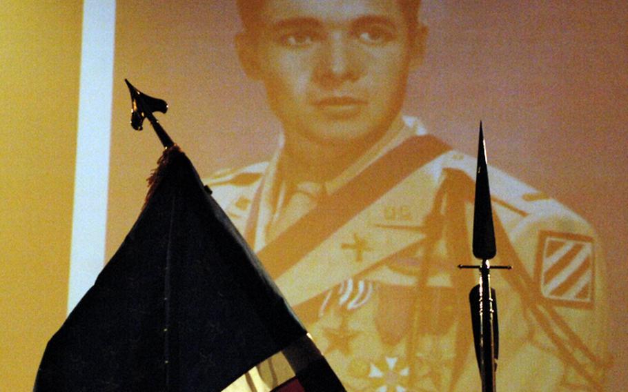 A photo of Audie Murphy, the most decorated American veteran of World War II, overlooks a Friday induction ceremony for the Sergeant Audie Murphy Club, an Army organization that recognizes top noncommissioned officers. The 172nd Separate Infantry Brigade in Grafenwöhr, Germany, inducted 14 of its soldiers into the club.